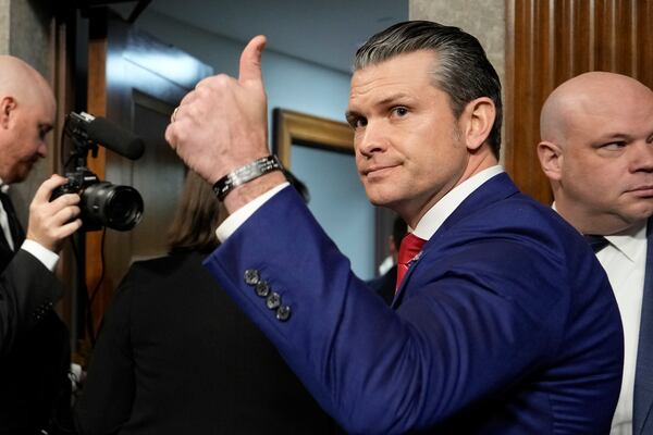 Pete Hegseth, who is nominated to be defense secretary, gives a thumbs-up after a Senate hearing.