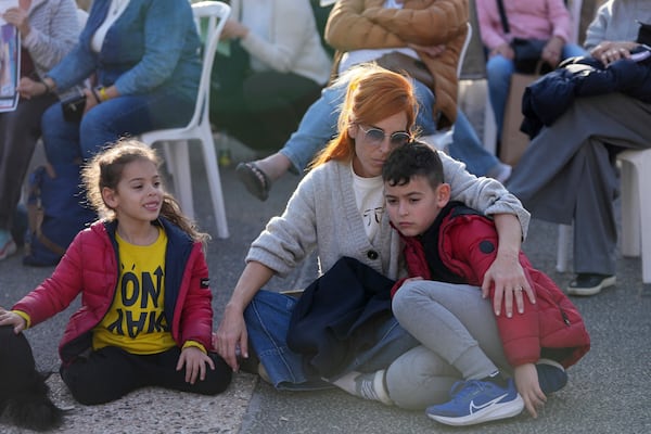 Relatives and friends of people killed and abducted by Hamas and taken into Gaza, gather in Tel Aviv, Israel on Sunday, Jan. 19, 2025. (AP Photo/Maya Alleruzzo)