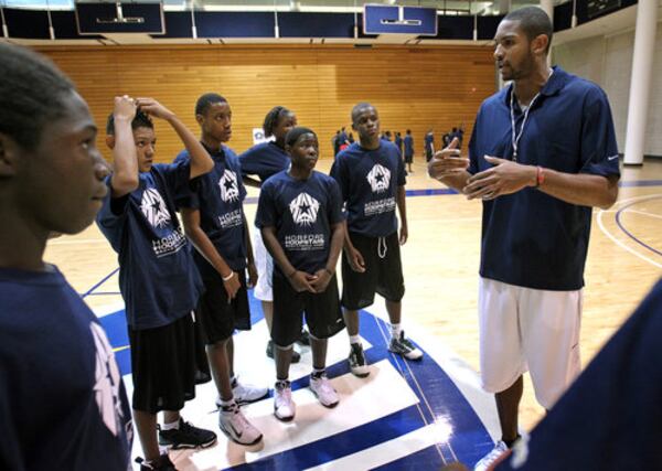 110625 Decatur; Atlanta Hawks forward Al Horford, right, talks to a group of older kids during Horford Hoopstars Basketball Camp at the Emory Woodruff Physical Education Center Saturday morning in Decatur, Ga., June 25, 2011. The camp was for kids ages 10 to 18 and around 120 campers where in attendance Saturday. Each camp will provide campers with a fun and competitive environment that will help participants improve their skills, and give them the unique opportunity to get one on one instruction from NBA All-Star Al Horford. Jason Getz jgetz@ajc.com "Take my advice: You'd rather tear a pectoral than break a foot." (Jason Getz/AJC)