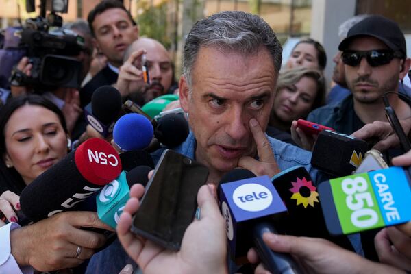 Yamandu Orsi, presidential candidate from the Broad Front, or Frente Amplio, talks to journalists after voting in the presidential run-off election in Canelones, Uruguay, Sunday, Nov. 24, 2024. (AP Photo/Matilde Campodonico)