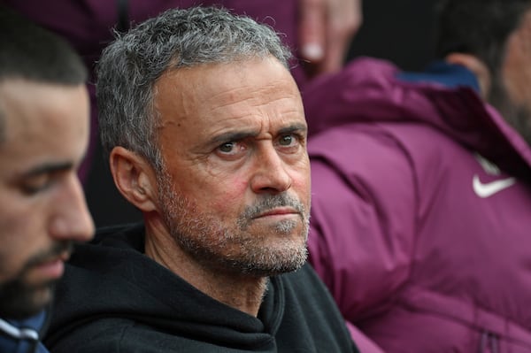 PSG's head coach Luis Enrique sits on the bench prior to the French League One soccer match between Rennes and Paris Saint-Germain at Roazhon Park stadium in Rennes, France, Saturday March 8, 2025. (AP Photo/Matthieu Mirville)