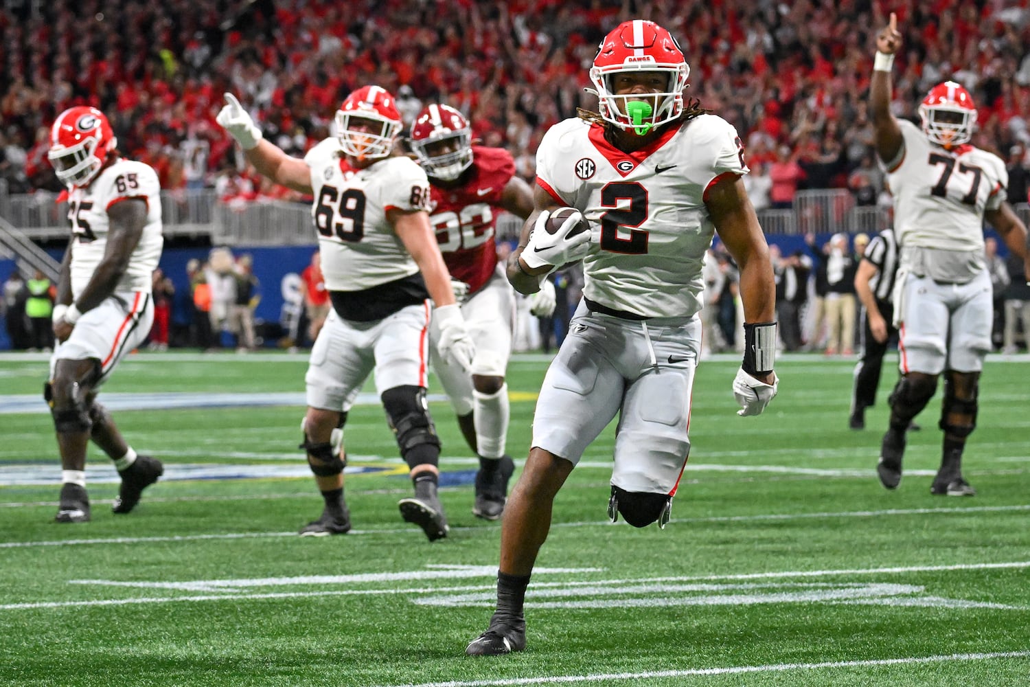 Georgia Bulldogs running back Kendall Milton (2) runs for a 17-yard touchdown against the Alabama Crimson Tide during the first half of the SEC Championship football game at the Mercedes-Benz Stadium in Atlanta, on Saturday, December 2, 2023. (Hyosub Shin / Hyosub.Shin@ajc.com)