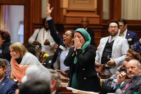 Rep. Imani Barnes (D-Tucker) and Rep. Ruwa Romman (D-Duluth) cheer after HB 233 fails to pass on Wednesday, March 29, 2023. The bill would send $6,000 a year to parents to help cover education-related costs, including private school tuition. (Natrice Miller/The Atlanta Journal-Constitution) 