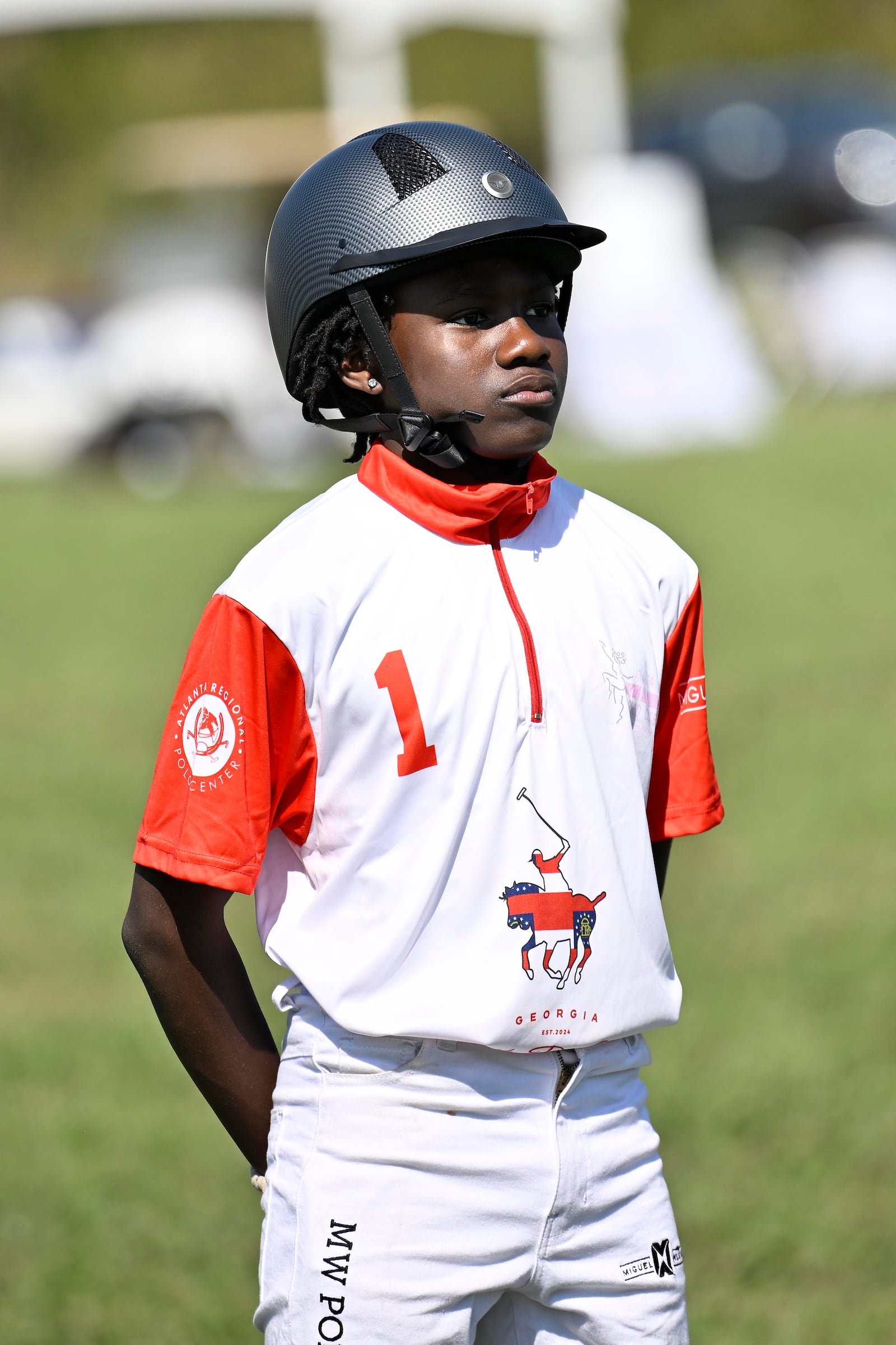 Caleb Choice Sanchez, a member of the B.E.S.T Academy Polo Team stands for the National Anthem before a match at the 7th Annual Atlanta Fashion and Polo Classic on Sunday, Oct. 13, 2024, in Fairburn, GA. (Jim Blackburn for the AJC)