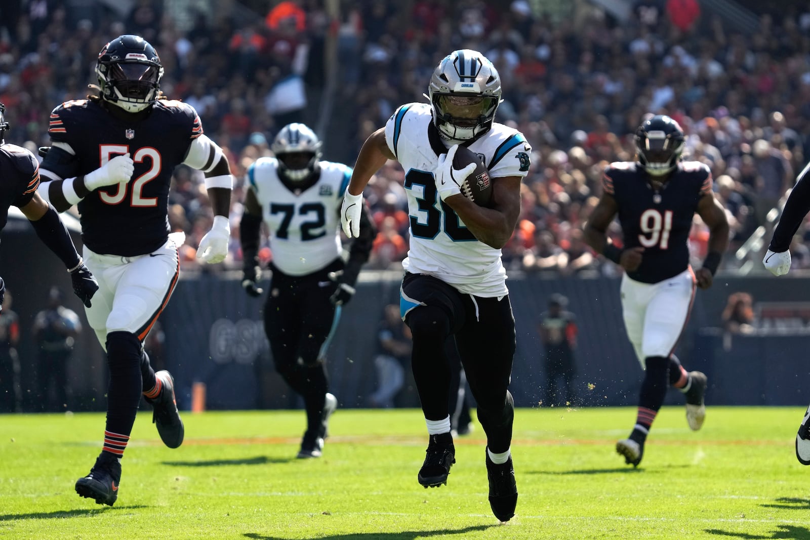 Carolina Panthers running back Chuba Hubbard (30) runs for a 38-yard touchdown against the Chicago Bears during the first half of an NFL football game Sunday, Oct. 6, 2024, in Chicago. (AP Photo/Nam Y. Huh)