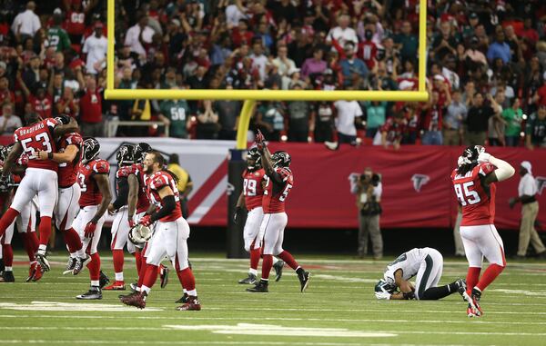 Philadelphia Eagles wide receiver Jordan Matthews (81) lies on the field after bobbling the ball and Atlanta Falcons cornerback Ricardo Allen (37) made the interception during the second half of an NFL football game, Monday, Sept. 14, 2015, in Atlanta. The Atlanta Falcons won 26-24. (AP Photo/John Bazemore)