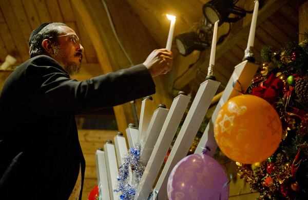 Rabbi Yossi Lerman lights the 10-foot menorah at Thrasher Park in Norcross on Sunday, December 9, 2012. This year, the celebration takes place on Dec. 6.