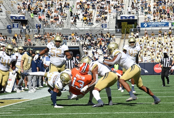 Clemson wide receiver Brannon Spector (13) gets tackled by Georgia Tech's defensive back Wesley Walker (39) and defensive back Juanyeh Thomas (1) during the first half Saturday, Oct. 17, 2020, at Bobby Dodd Stadium in Atlanta.