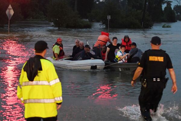 People are rescued from a hotel by boat after Hurricane Harvey caused heavy flooding in Houston, Texas on August 27, 2017. 
Massive flooding unleashed by deadly monster storm Harvey left Houston -- the fourth-largest city in the United States -- increasingly isolated as its airports and highways shut down and residents fled homes waist-deep in water.