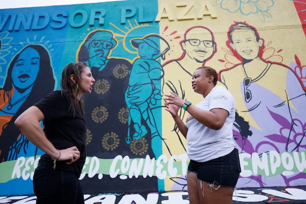 DeMicha Luster (right), founder of The Urban Advocate, speaks with Katie Howard, the district 1 representative for the Atlanta Public Schools board of education, in front of the gun violence prevention mural the organization created weeks ago. (Miguel Martinez / miguel.martinezjimenez@ajc.com)