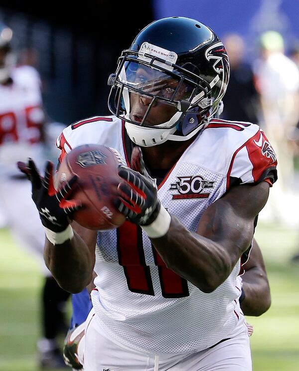 Atlanta Falcons wide receiver Julio Jones (11) makes a catch near the end zone on a pass from quarterback Matt Ryan, not pictured, as New York Giants cornerback Prince Amukamara (20) defends on the play during the second half of an NFL football game, Sunday, Sept. 20, 2015, in East Rutherford, N.J. (AP Photo/Seth Wenig)