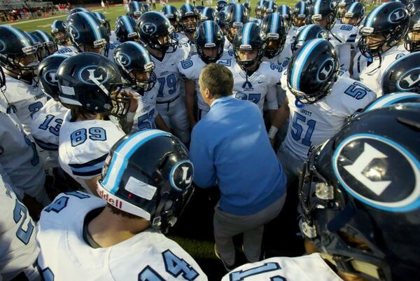 October 30, 2015 - Norcross, Ga: Lovett head coach Mike Muschamp, center, talks with Lovett players before their game against GAC at Greater Atlanta Christian Friday in Norcross, Ga., October 30, 2015. PHOTO / JASON GETZ