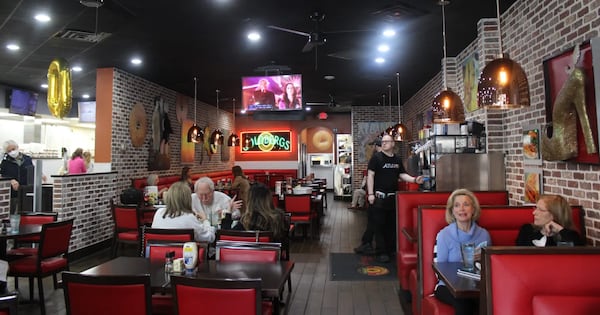 Diners enjoy a late breakfast at Goldbergs Fine Foods on Roswell Road in Buckhead earlier this week. Once a tiny space on Roswell Road, the deli added a dining room in the mid-1990s. The restaurant celebrates its 50th anniversary April 1. (Courtesy of Dyana Bagby)