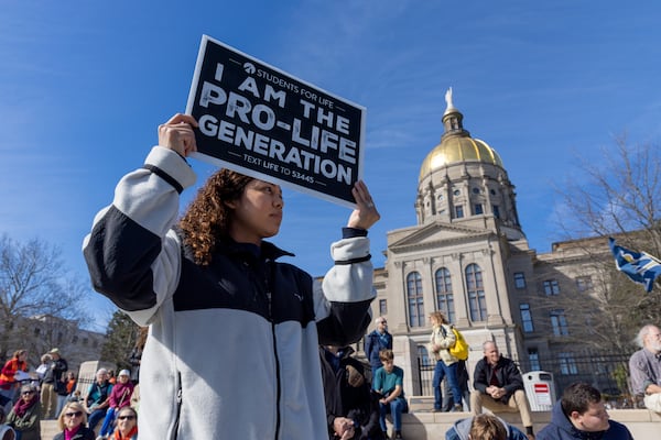 Katherine Najera of Atlanta, who is with Essie’s Ministries, holds a sign at the annual March for Life rally in Atlanta on Friday, January 20, 2023, the first march since Roe v. Wade was overturned. (Arvin Temkar / arvin.temkar@ajc.com)