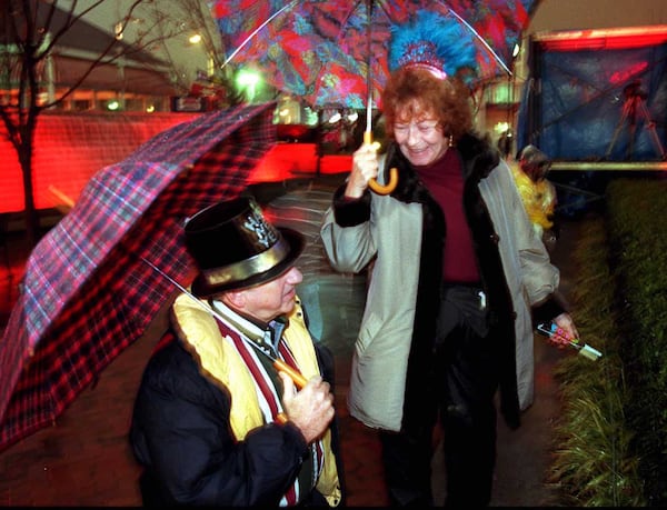 New Years Eve at Underground Atlanta. Being a little early for the Peach Drop, however, Pat and Lawton Castleberry, from Northeast Atlanta, brave the weather conditions to enjoy the atmosphere at Underground. Photo: Philip McCollum / Staff 12/31/95