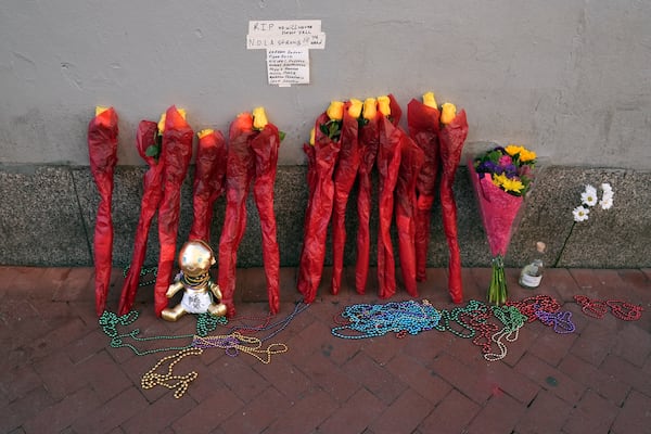 A memorial of flowers is set up on Canal and Bourbon Street, Thursday, Jan. 2, 2025 in New Orleans. (AP Photo/George Walker IV)