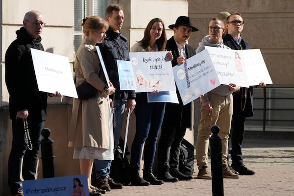 Protesters stand outside the newly opened center where women can go to have abortions with pills, during its inauguration, in Warsaw, Saturday March 8, 2025. (AP Photo/Czarek Sokolowski)