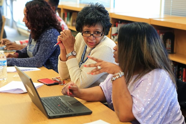 Angela Fortson (left), academic counselor for Atlanta Public Schools, speaks to fellow counselor Erica Sansbury-Clark (right) during a training session on how to use a new computer-based college search tool on Monday, Jan. 27, 2020, at Maynard Jackson High School in Atlanta. (Christina Matacotta/crmatacotta@gmail.com)