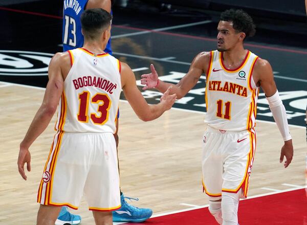 Atlanta Hawks guard Trae Young (11) celebrates a score with teammate guard Bogdan Bogdanovic (13) in the second half of an NBA basketball game against the Orlando Magic Thursday, May 13, 2021 in Atlanta. (AP Photo/Tami Chappel)