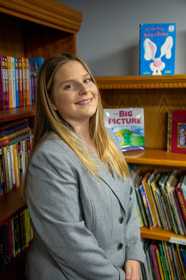 Josie Dunlap with some of the books she stocked in the resource room at Eastside Mosaic Church in Marietta. PHIL SKINNER FOR THE ATLANTA JOURNAL-CONSTITUTION.