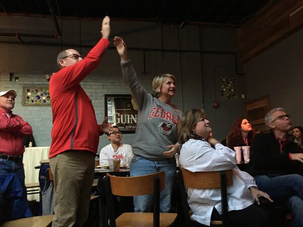 Fans high five near the beginning of the Rose Bowl Monday.