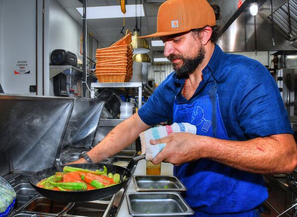 Chef Shay Lavi prepares Shay Lavi's Roasted Okra in the kitchen of Nur Kitchen on Buford Highway. (Styling by chef Shay Lavi / Chris Hunt for the AJC)