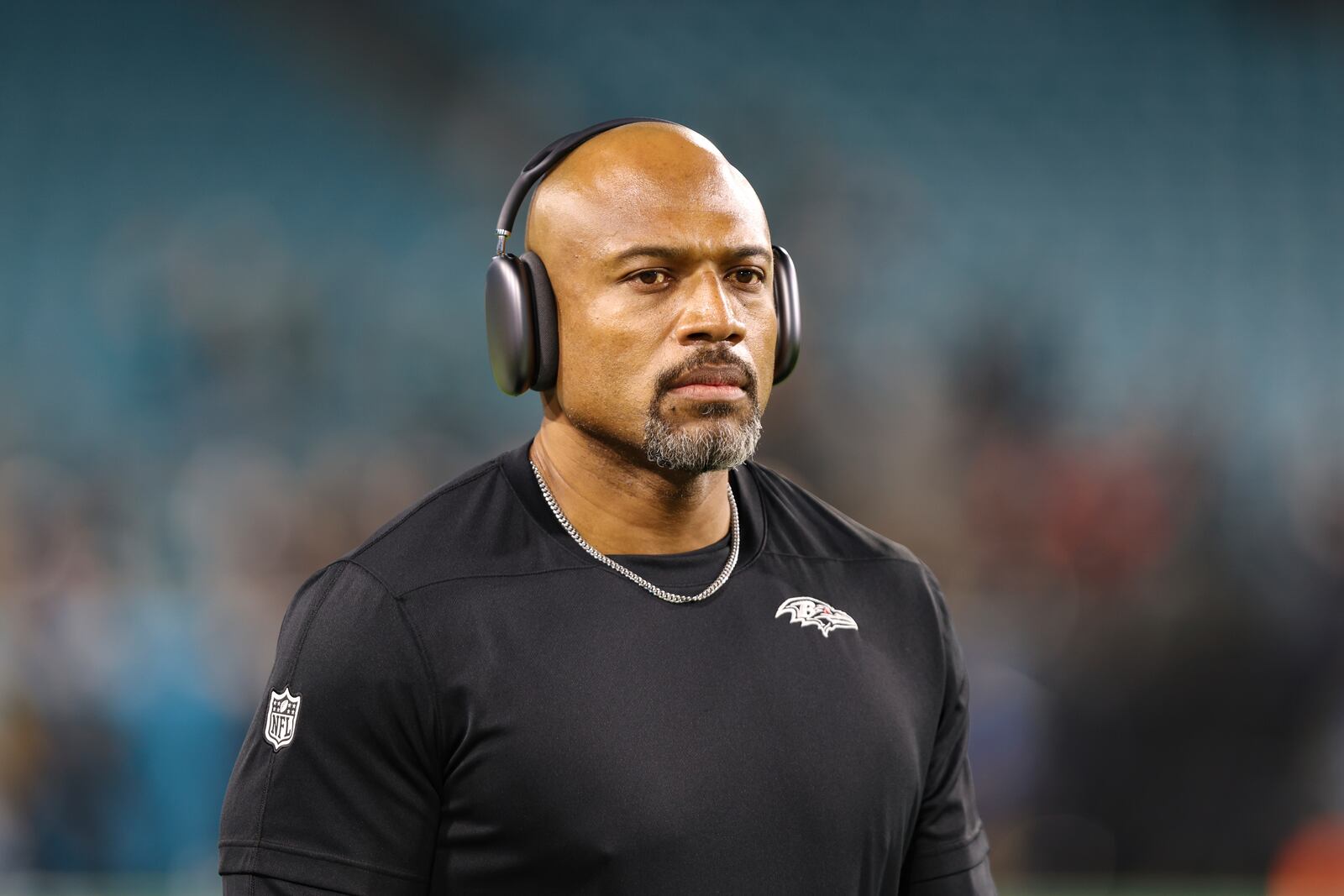 Baltimore Ravens assistant head coach/defensive line Anthony Weaver walks the field before an NFL football game against the Jacksonville Jaguars, Sunday, Dec. 17, 2023, in Jacksonville, Fla. The Ravens defeated the Jaguars 23-7. (AP Photo/Gary McCullough)