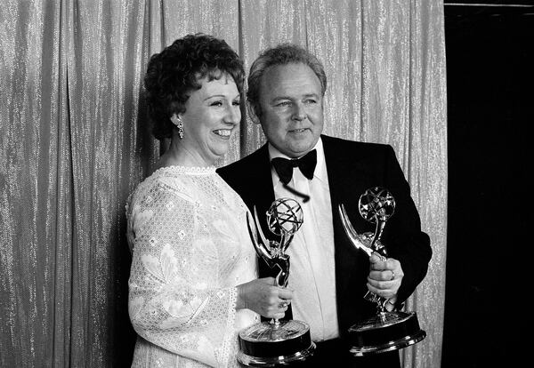 Actors Carroll O'Connor, left, and Jean Stapleton, who co-star in CBS-TV's comedy series "All In The Family" smile as they hold the Emmys they won, May 15, 1972, in Hollywood, for Best Actor and Best Actress in a comedy series.  (AP Photo/David F. Smith)