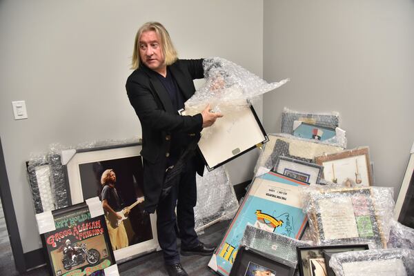  Conlon goes through memorabilia, which will soon adorn the walls of the venue. Photo: HYOSUB SHIN / HSHIN@AJC.COM