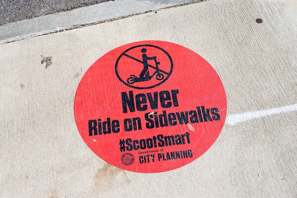 10/17/2019 -- Atlanta, Georgia -- A message from the Atlanta Department of City Planning is displayed on the sidewalk along {each tree Street NE in Atlanta's Midtown community, Thursday, October 17, 2019. (Alyssa Pointer/Atlanta Journal Constitution)