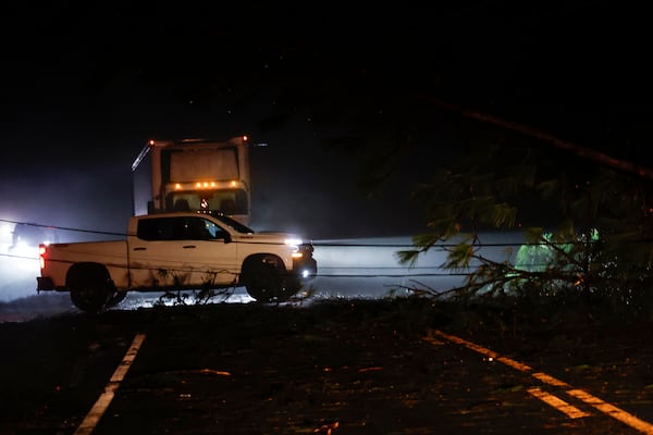 Downed trees and power lines block a road along Highway 82 after a tornado passed through, Sunday, March 16, 2025, in Maplesville, Ala. (AP Photo/Butch Dill)