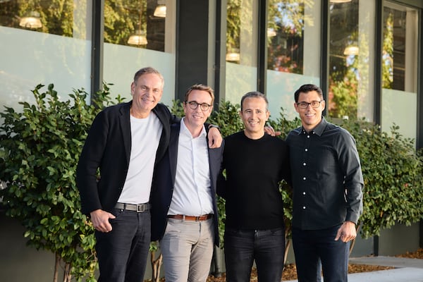 From left to right: Volkswagen Group CEO Oliver Blume, VW's Carsten Helbing, Rivian's Wassym Bensaid and Rivian CEO R.J. Scaringe. (Courtesy Rivian and Volkswagen Group)