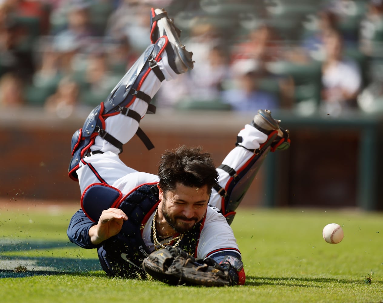 Atlanta Braves' Travis d'Arnaud dives for a foul ball during the fourth inning of game one of the baseball playoff series between the Braves and the Phillies at Truist Park in Atlanta on Tuesday, October 11, 2022. (Jason Getz / Jason.Getz@ajc.com)