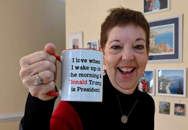 Cherokee County Republican Judy Griffin holds up a mug that shows her support for Donald Trump on Tuesday, January 14, 2025, in Woodstock. Judy and Brian Griffin are traveling to Washington D.C. for Trump's second inauguration. (Hyosub Shin/AJC)