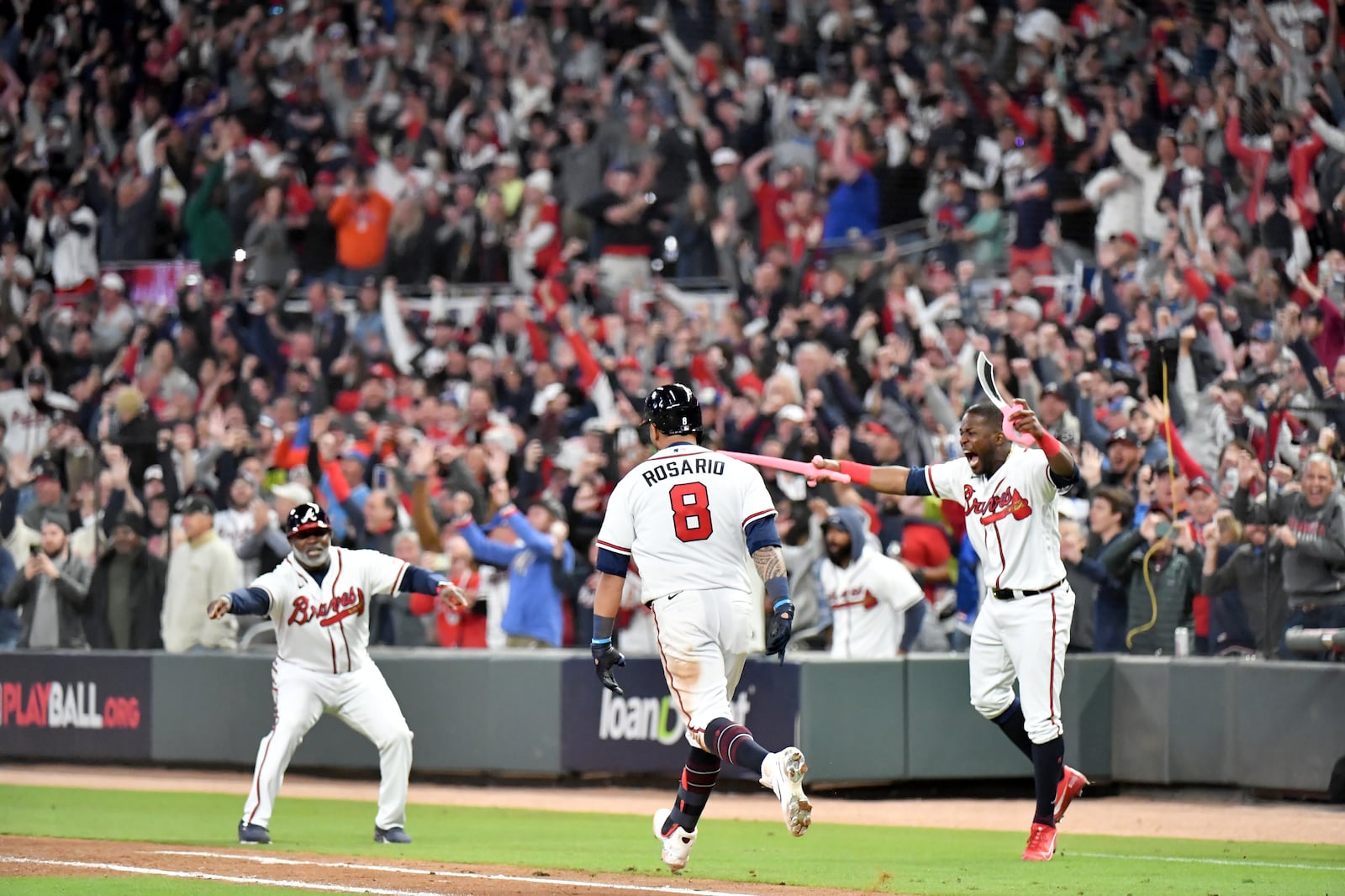 Braves outfielder Guillermo Heredia (right) begins the celebration after leftfielder Eddie Rosario (8) hit the walk-off single that scored shortstop Dansby Swanson in the ninth inning against the Los Angeles Dodgers in Game 2 of the NLCS Sunday, Oct. 17, 2021, at Truist Park in Atlanta. The Braves won 5-4 to take a 2-0 series lead. (Hyosub Shin / Hyosub.Shin@ajc.com)