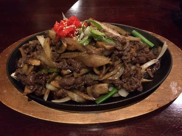 The owners of Natsu Sushi Bar & Ocean Grill in Alpharetta are Korean, and they offer cuisine from their homeland like this platter of bulgogi (grilled beef) with mushrooms and onions. CONTRIBUTED BY WENDELL BROCK