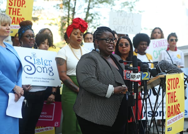 Monica Simpson, executive director of Georgia-based reproductive justice organization SisterSong, has been named to Time magazine’s list of the “100 Most Influential People of 2023.” She is pictured at a microphone in 2019. (Christina Matacotta for the AJC)