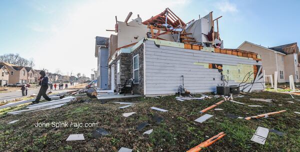 There were no reports of injuries in the Jumpers Trail neighborhood, but cars and homes were seriously damaged. JOHN SPINK / AJC