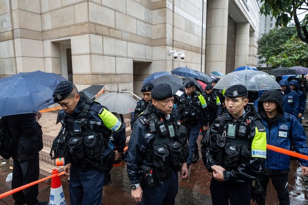 Police stand guard outside the West Kowloon Magistrates' Courts in Hong Kong, Wednesday, Nov. 20, 2024. (AP Photo/Chan Long Hei)