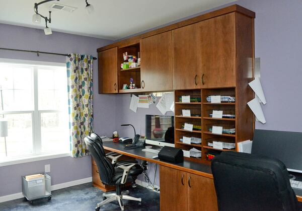 Tired of working at her dining room table, Grifenhagen Zhiss finished the basement of her Mableton home with a separate office space for her business, Apex Logistics. The Duralee fabric she selected for the custom curtains inspired the lavender hue for the room, which has a custom work center crafted by Jesse Rumsey Cabinets.