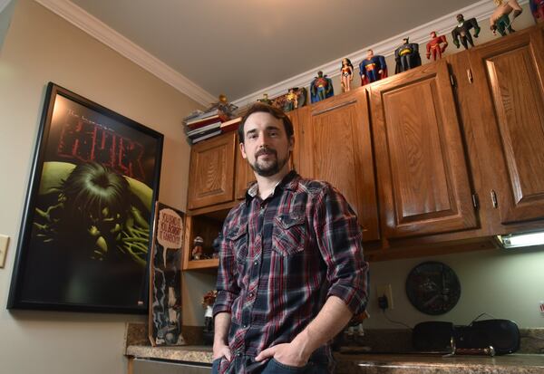 “I was obsessed with the idea of half-orcs as a biker gang and was planning to run it as a Dungeons & Dragons game. Why not write it as a book?” fantasy author Jonathan French, shown at his Norcross home, says of his novel “The Grey Bastards.” HYOSUB SHIN / HSHIN@AJC.COM