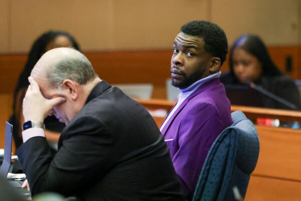 Deamonte Kendrick sits next to his defense attorney in the ongoing Fulton County gang and racketeering trial. (Jason Getz / jason.getz@ajc.com)