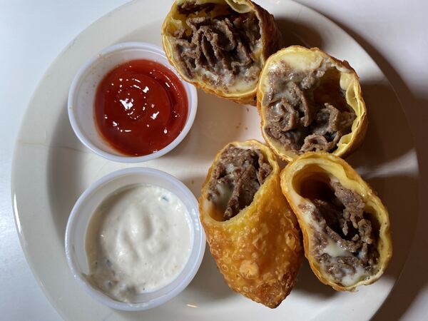 At Iron Hill, you can get Philly cheesesteak egg rolls with fried onions, American cheese, ketchup and horseradish sauce. Bob Townsend for The Atlanta Journal-Constitution 