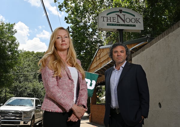 The Nook on Piedmont Park’s co-owner Katherine Drolett and her business partner David Duley stand outside her restaurant on Wednesday, July 12, 2023, in Atlanta. Drolett and Duley are locked in a legal battle with the Piedmont Park Conservancy over a sinkhole that emerged under a building on the edge of the park owned by the conservancy that they were renovating for two planned restaurants. (Hyosub Shin/AJC)