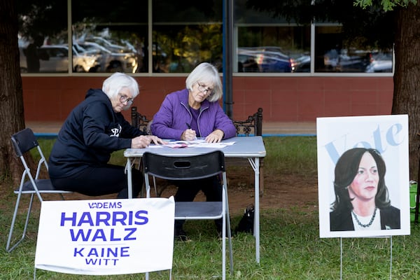 Ellen Shrum and Jeanette Rosenberg write postcards at IX Art Park in Charlottesville, Va., Thursday, Oct. 10, 2024. Charlottesville Democrats meet weekly to make phone calls, write postcards and send texts to get out the vote. (AP Photo/Ryan M. Kelly)