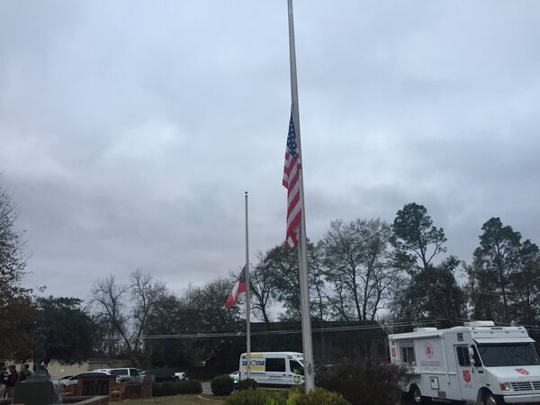 A flag flies at half-staff at the command center after two officers were shot Wednesday in Americus. (Credit: Channel 2 Action News)