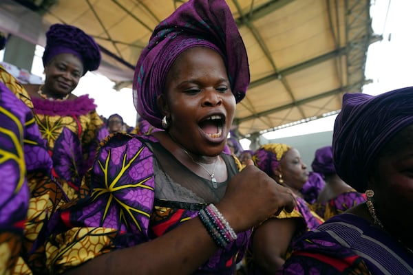 A women sing and dance during the International Women's Day celebration at the Mobolaji Johnson Stadium in Lagos, Nigeria, Friday, March. 7, 2025. (AP Photo/Sunday Alamba)