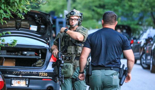 Cobb County SWAT and police officers respond to a home on Millwood Drive, where a man wanted out of Cherokee County was barricaded inside. JOHN SPINK / JSPINK@AJC.COM