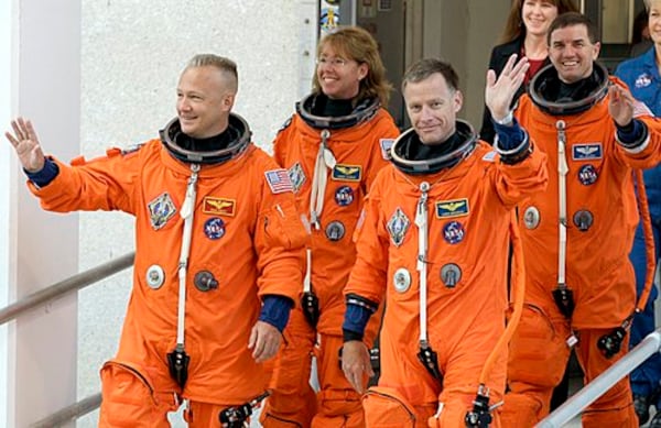 The space shuttle Atlantis astronauts, (left to right) pilot Doug Hurley, mission specialist Sandy Magnus, commander Chris Ferguson and mission specialist Rex Walheim, leave the operations and checkout building on their way to the pad at the Kennedy Space Center Friday, July 8, 2011, in Cape Canaveral, Fla. Atlantis is the 135th and final space shuttle launch for NASA. (Associated Press)