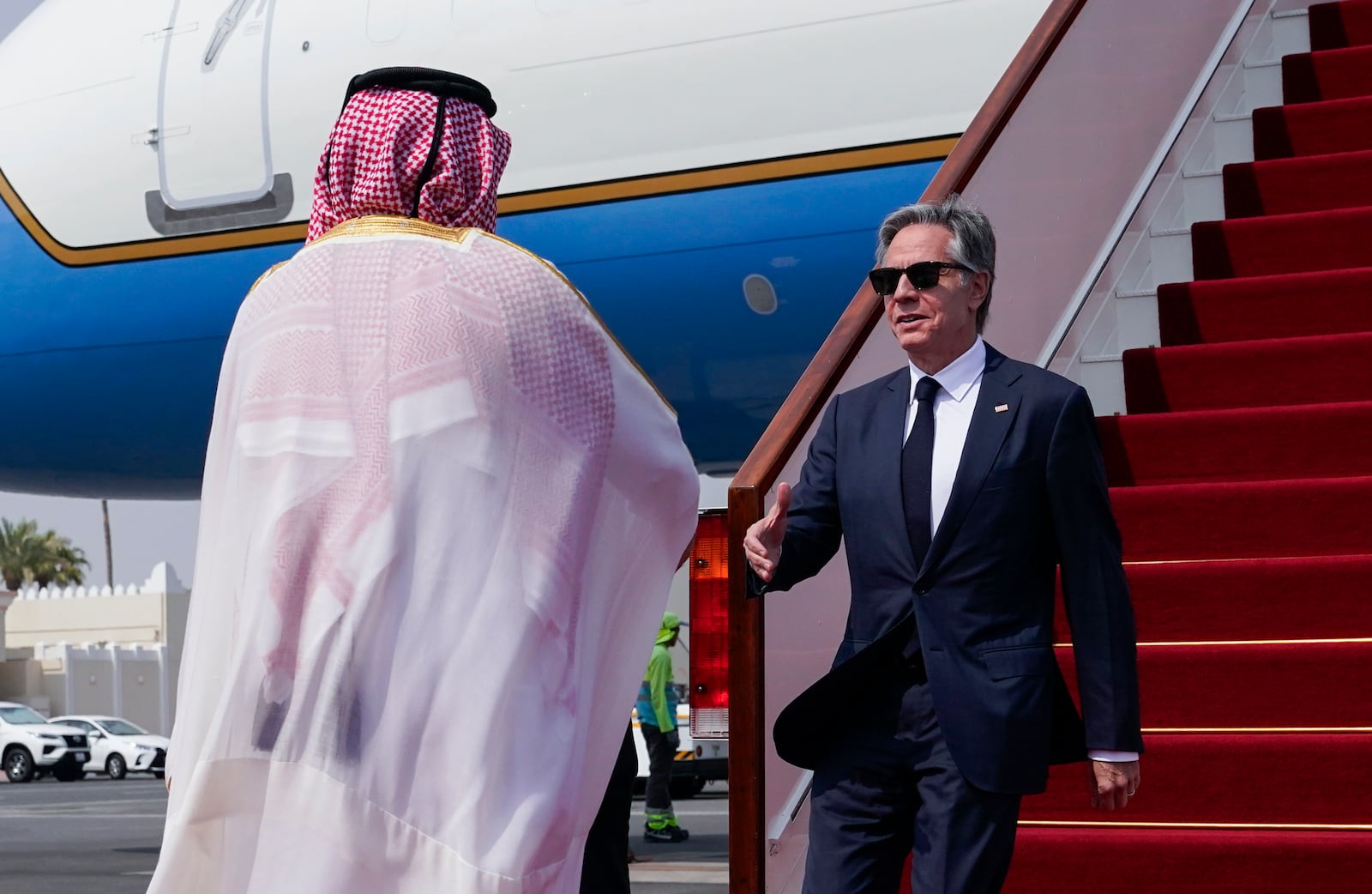 Qatari Ministry of Foreign Affairs Chief of Protocol Ibrahim Fakhroo welcomes U.S. Secretary of State Antony Blinken, right, as he arrives in Doha, Qatar, Thursday, Oct. 24, 2024. (Nathan Howard/Pool Photo via AP)